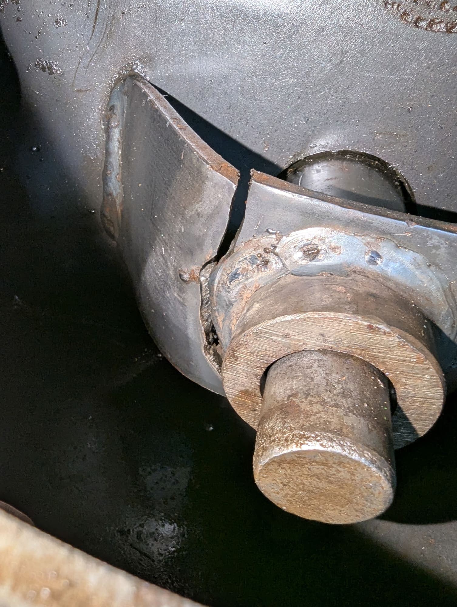 Bracket split through beside its mounting pin