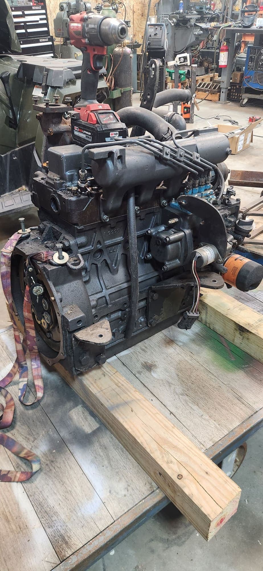Rebuilt diesel engine sitting on a bench in the shop, ready to go back in