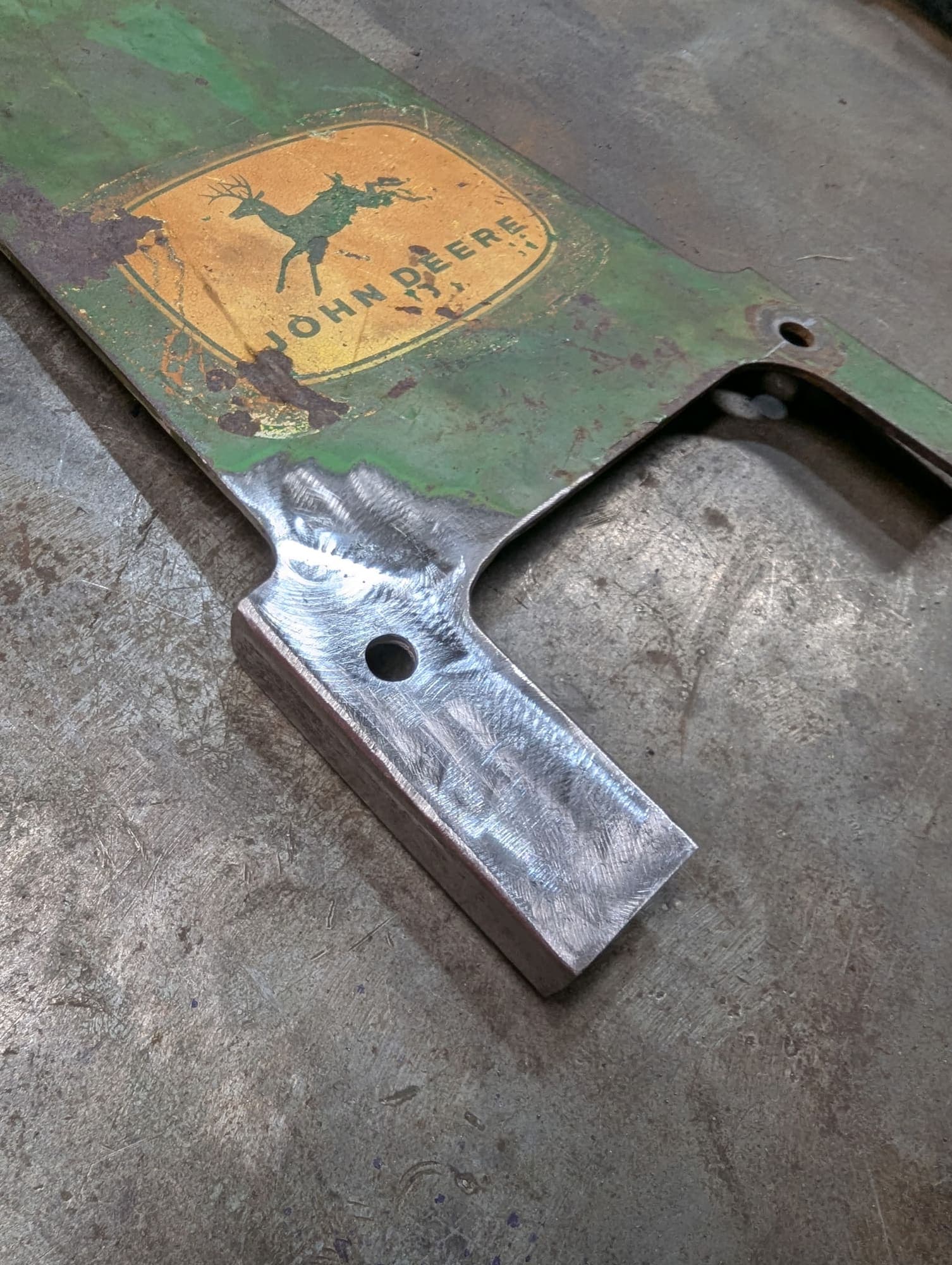 Fresh weld and a fabricated block on a John Deere seat bracket