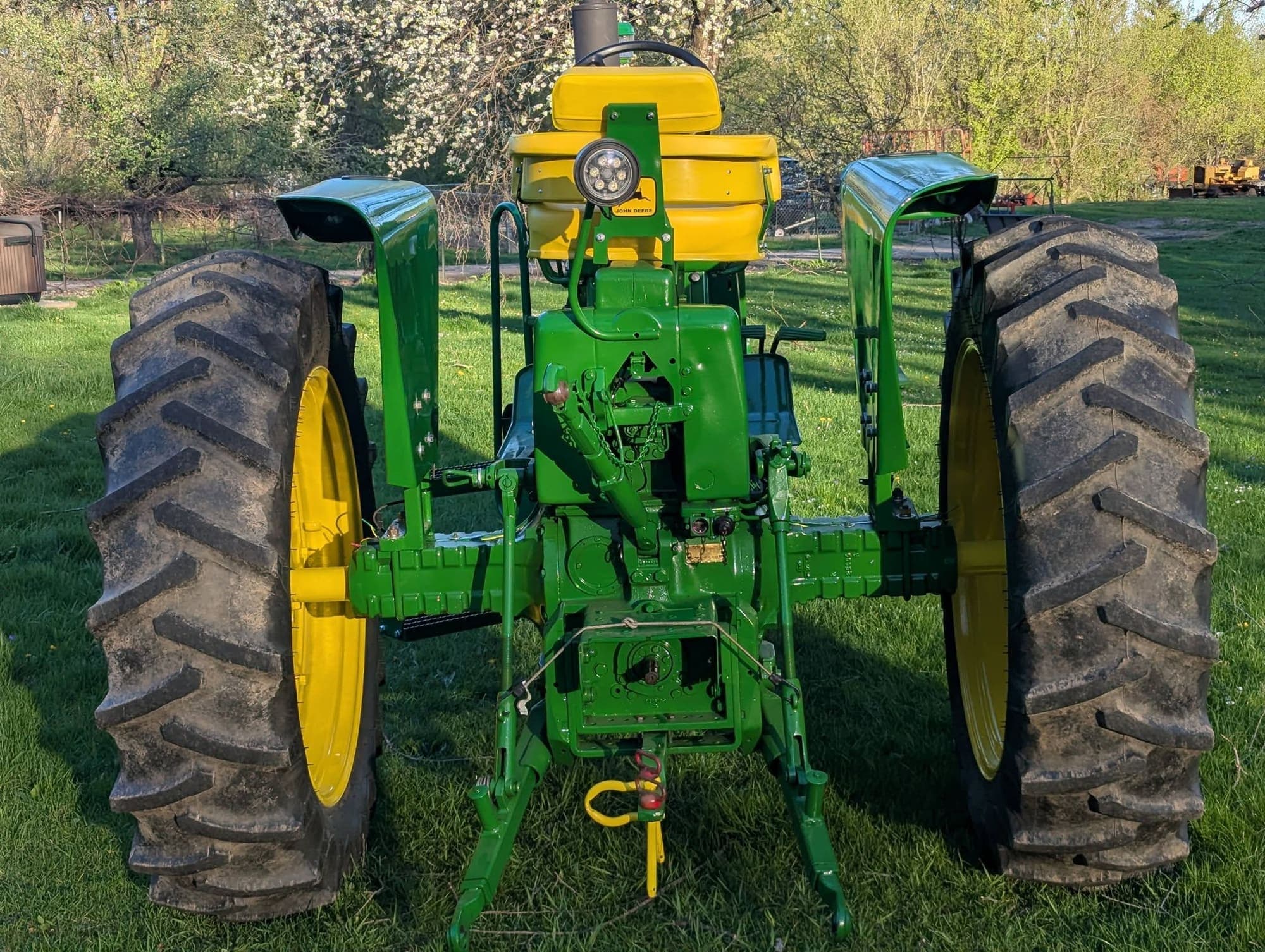 Rear view of the restored John Deere 3010, fresh paint on the fenders and a new seat