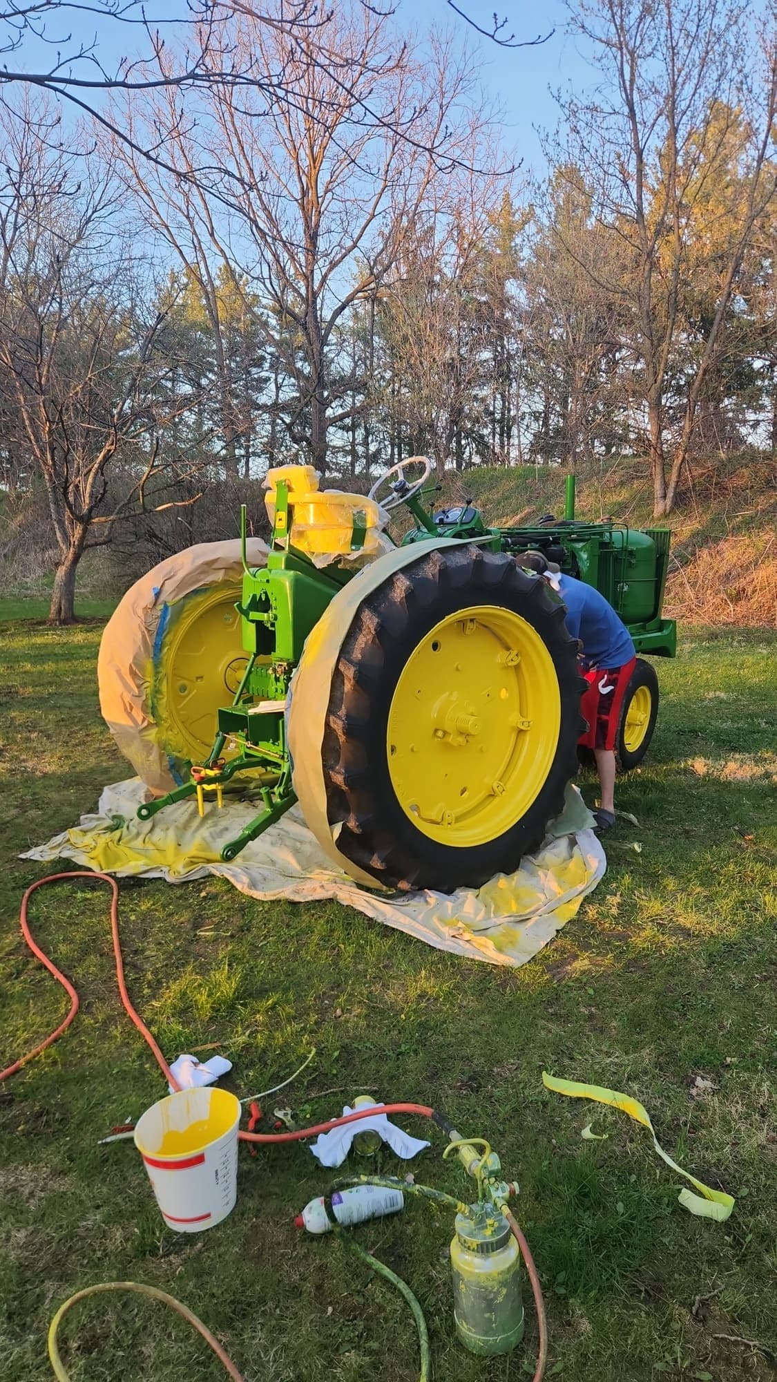Tractor masked and taped off for a repaint outside the shop